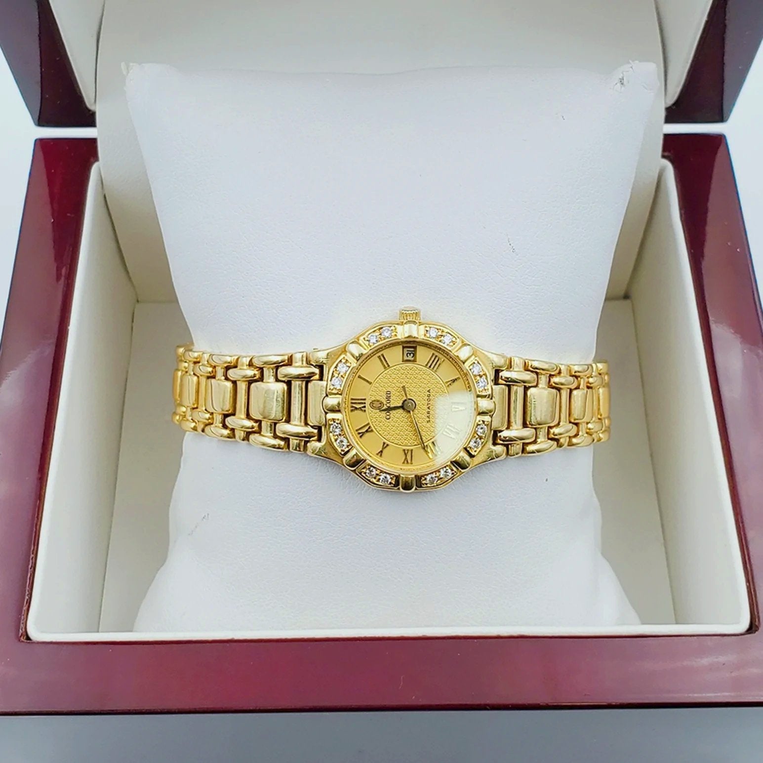 Ladies Concord Sarento 24mm Solid 18K Yellow Gold Wristwatch with Roman Numeral Gold Dial & Diamond Bezel. (Pre-Owned)