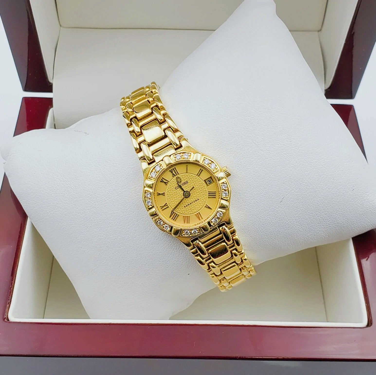 Ladies Concord Sarento 24mm Solid 18K Yellow Gold Wristwatch with Roman Numeral Gold Dial & Diamond Bezel. (Pre-Owned)